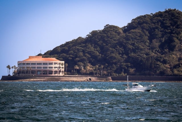 VIP Model Escorts in Kawasaki 10 a boat in the water near a large building
